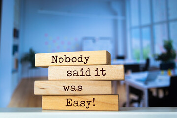 Wooden blocks with words 'Nobody said it was easy'. Business concept