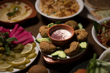 Falafel is served at a Syrian restaurant, accompanied by a creamy dipping sauce with sour sumac.