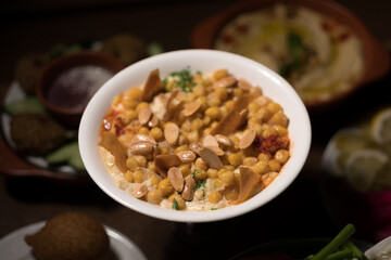 Chickpeas, fried pita, and yogurt are mixed to create fatteh, a popular dish across the Middle East.