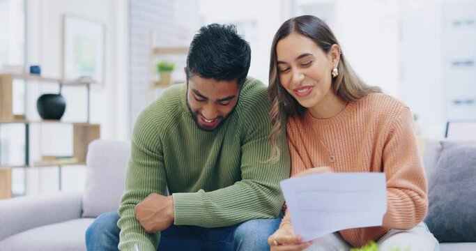 Home, documents and happy couple on sofa with mortgage application, financial management and budget success. Biracial people on couch in their apartment with paperwork for title deed, loan or finance