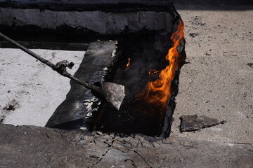 Heating Roll Of Bitumen Roofing Felt With Gas Torch Flame