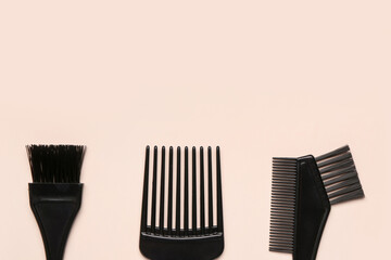 Hairdresser's brushes on beige background