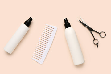 Hair sprays with comb and brush on beige background