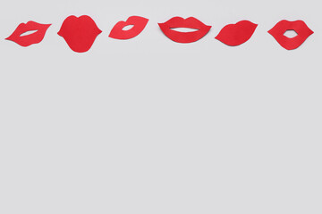 Red paper lips on light background
