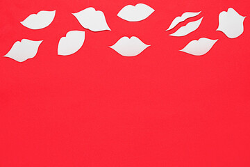 Pink paper lips on red background