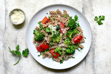 hole grain pasta fusilli with grilled bell pepper and broccoli. Top view with copy space.
