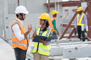 India engineer woman and Asia engineer man working with document at precast site work	