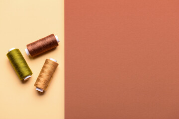 Set of sewing threads on color background