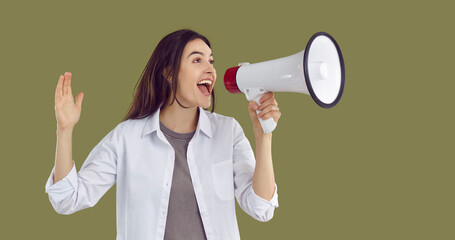 Woman advertising something and screaming through loudspeaker. Excited young girl in white shirt...