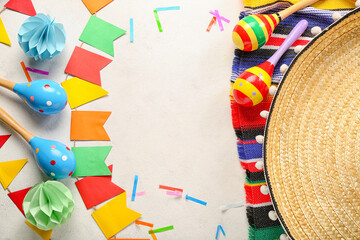 Frame made of Mexican maracas with flags and confetti on white background