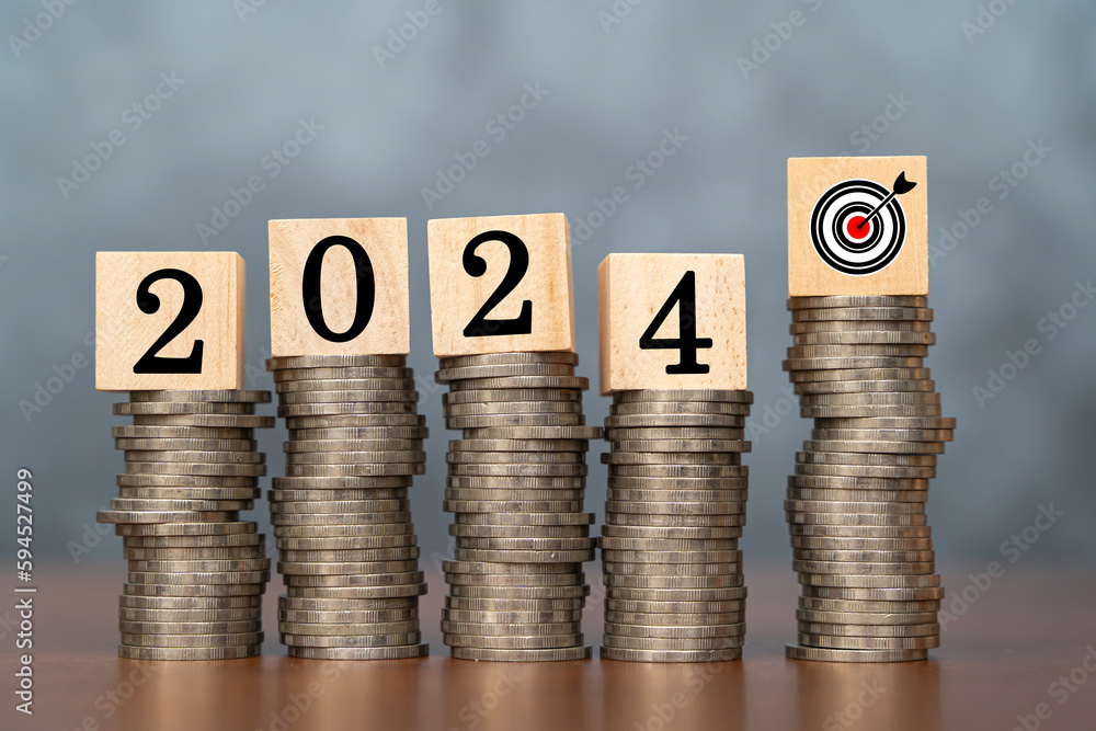 Aufkleber 2024 wooden cube and target on stack of coins with dark background and copy space. money saving idea