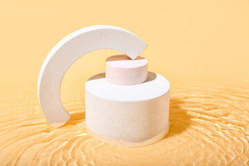 Plaster podiums in water on beige background