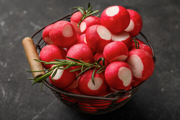 Basket with fresh radish on dark background, closeup