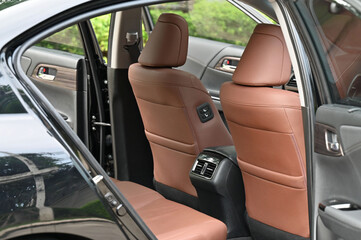 inside the back seat The passenger seat is wide and clean. Leather interior design, car passenger...