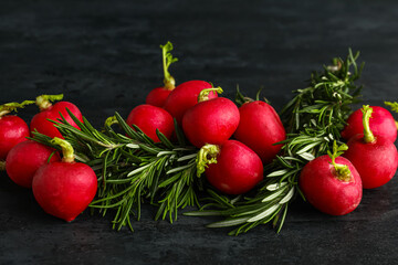 Heap of fresh radish on dark background
