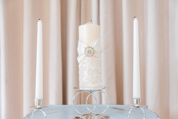 Three Decorative White Candles on Table