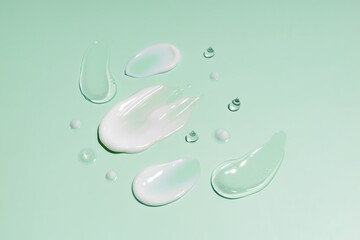 cosmetic smears cream texture on green background. Beauty serum drop. Transparent and creamy skin care product sample. - obrazy, fototapety, plakaty