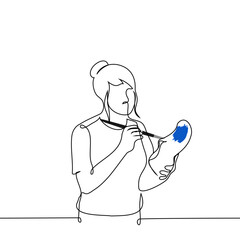 woman paints sneakers with brush - one line drawing vector. concept shoe customization, homemade shoes, custom shoes