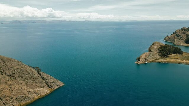 Breathtaking drone footage showcases the stunning natural beauty of the majestic Titicaca Lake flanked by two majestic headlands on both sides.