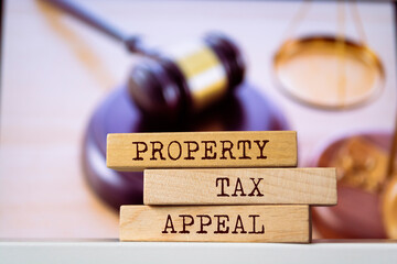 Wooden blocks with words 'Property Tax Appeal'. Legal concept