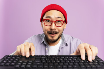 Excited Korean hipster playing video game. Amazed asian man wearing red hat, eyeglasses shopping...