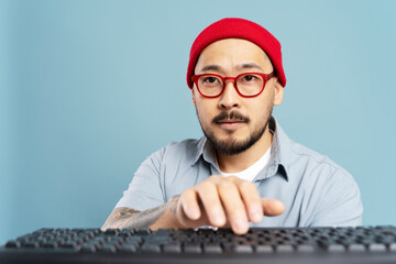Portrait of pensive asian copywriter typing on keyboard, working freelance project, communication...