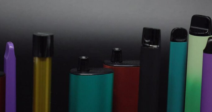 A lot of electronic cigarettes and vapes . The concept of bad habits.