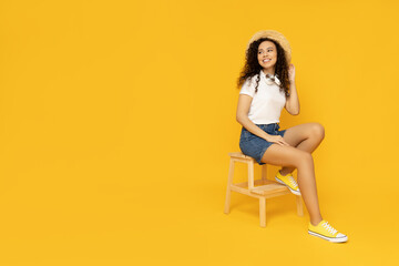 Fototapeta na wymiar Young woman in casual summer wearing on yellow background
