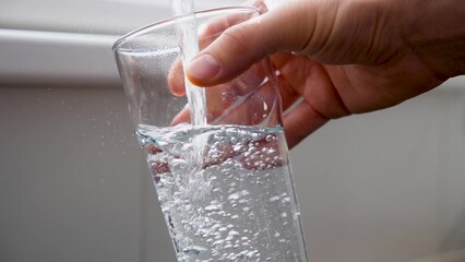 Man pouring clean tap drinking water into the clean glass on sunny day. - Powered by Adobe