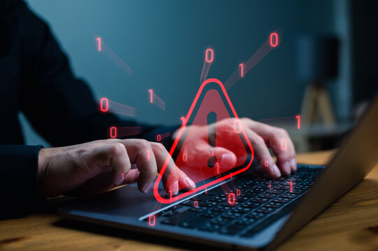Businessman or it staffs, programmer, developer using computer laptop with triangle caution warning sign for notification error and maintenance concept, System warning hacked alert, cyberattack.