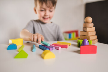 Happy boy play with plastiline and constructor. Kids hands with colorful clay. Close up.  Early...