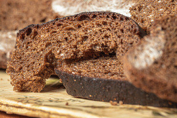 Dry musty bread. Spoiled, non-consumable food. Slices of black bread, covered with mold. Mold on bread