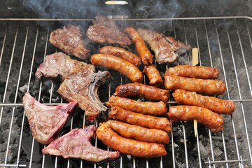 ITALY CANOSA DI PUGLIA APRIL 21 2023 LAMB RIBS AND GRILLED PORK SAUSAGES