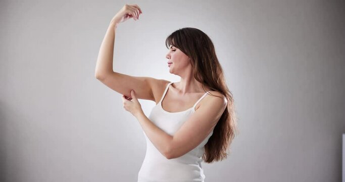 Women Testing Arm Fat Before Liposuction