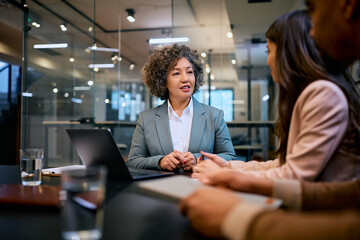 Financial consultant having meeting with young couple in office.