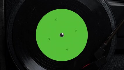 Close up of a vintage retro vinyl record with green sticker rotating. Top view. Old fashioned music. Needle gramophone. 4K ProRes - Powered by Adobe