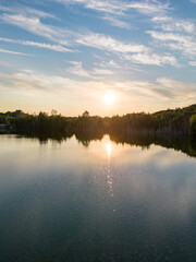 Aerial panorama Early Sunrise over forest lake. Noctilucent night clouds, summer foggy lake reflects sky. High quality photo