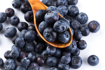 Fresh blueberries in wooden spoon