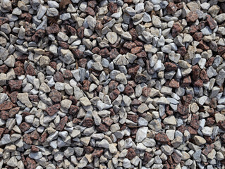 Gravel seamless texture close up..Gray and brown gravel stones for the construction industry.Small stones gravel background, . decoration in the gardening top view