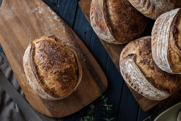 Artisan Batard Sourdough healthy Bread with leaf scoring. Open crumb high hydration Sourdough bread set on white table. - 594565219