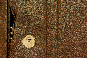 large durable lock is broken in a metal door close-up