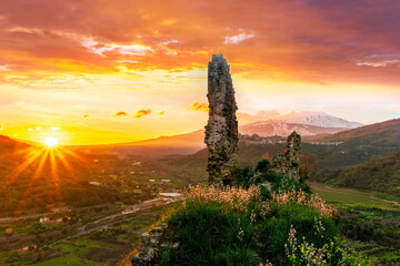 picturesque view from a mountain with ancient monument or castle ruins to a green valley with...
