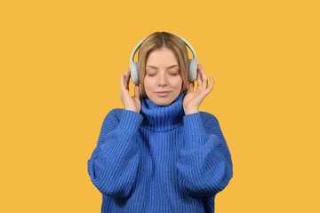 young pretty woman enjoying music in headphones