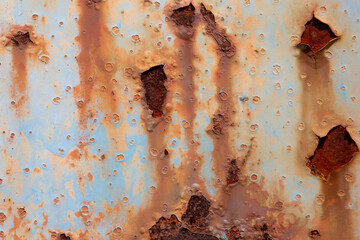 Rusted steel plate. Abandoned house, ruins. Metal. Background material. Stone, rock, etc…
