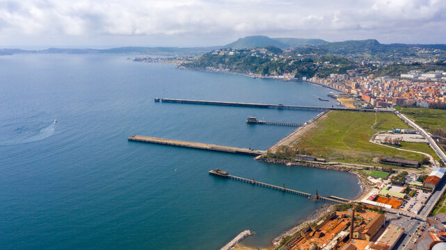 Aerial view of the ex Italsider area of Bagnoli from the Posillipo hill, in the metropolitan city of Naples, Campania, Italy. It's a disused industrial complex on the coast of Mediterranean sea.