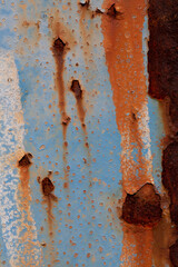 Rusted steel plate. Abandoned house, ruins. Metal. Background material. Stone, rock, etc…