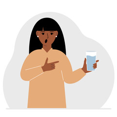 A woman holds a glass of water in his hand. The concept of water balance and health.