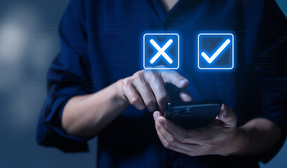 Businessman using smartphones show right and wrong symbols. yes or no decision	
