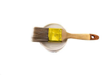 Paint brush on top of a paint pot, isolated on white background. Bristles can be made of various materials, such as natural hair, synthetic fibers, or a combination of both.