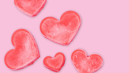 Fototapeta na wymiar Red ice cream in a heart shape on a pink background.